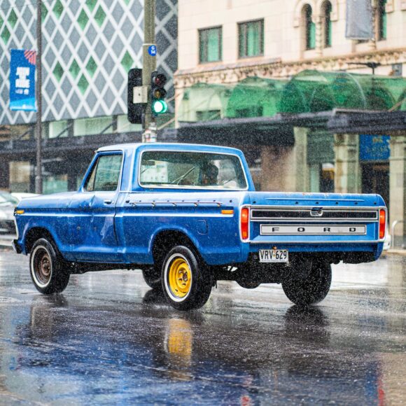 a blue pickup truck on the road