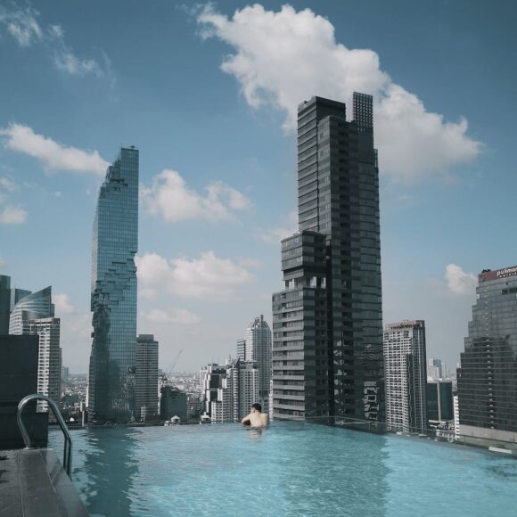 person in pool looking at the buildings