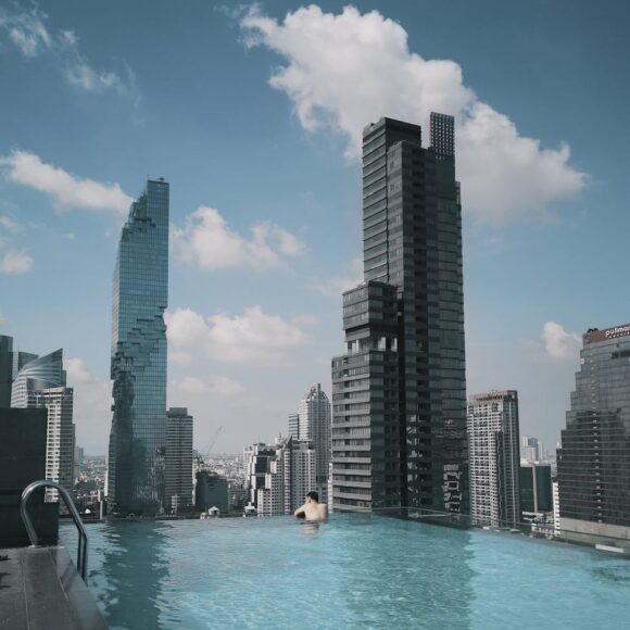 person in pool looking at the buildings