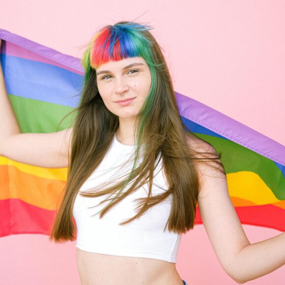 woman holding a gay pride flag
