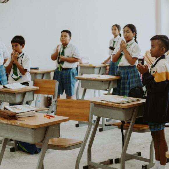 children in school uniforms in classroom