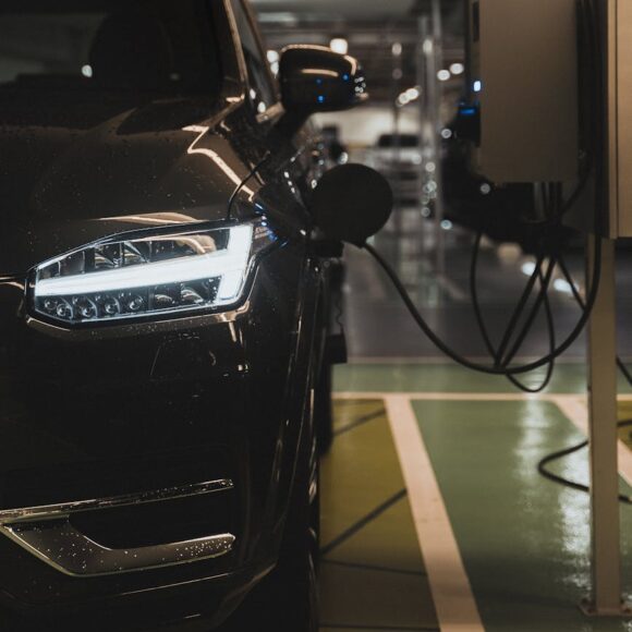 a black electric vehicle charging on a charging station